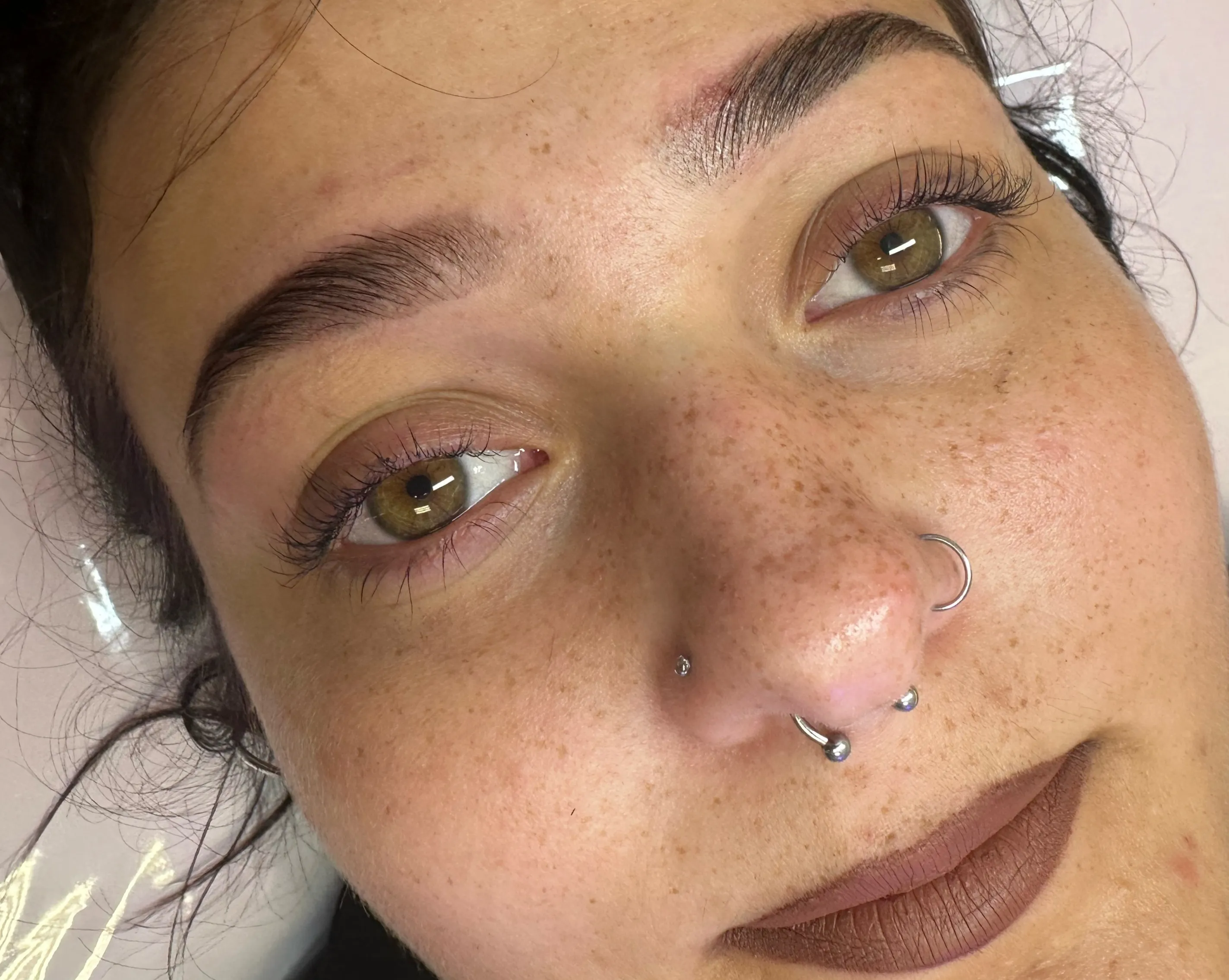 Close-up of dark, neatly defined eyebrows and natural lashes.