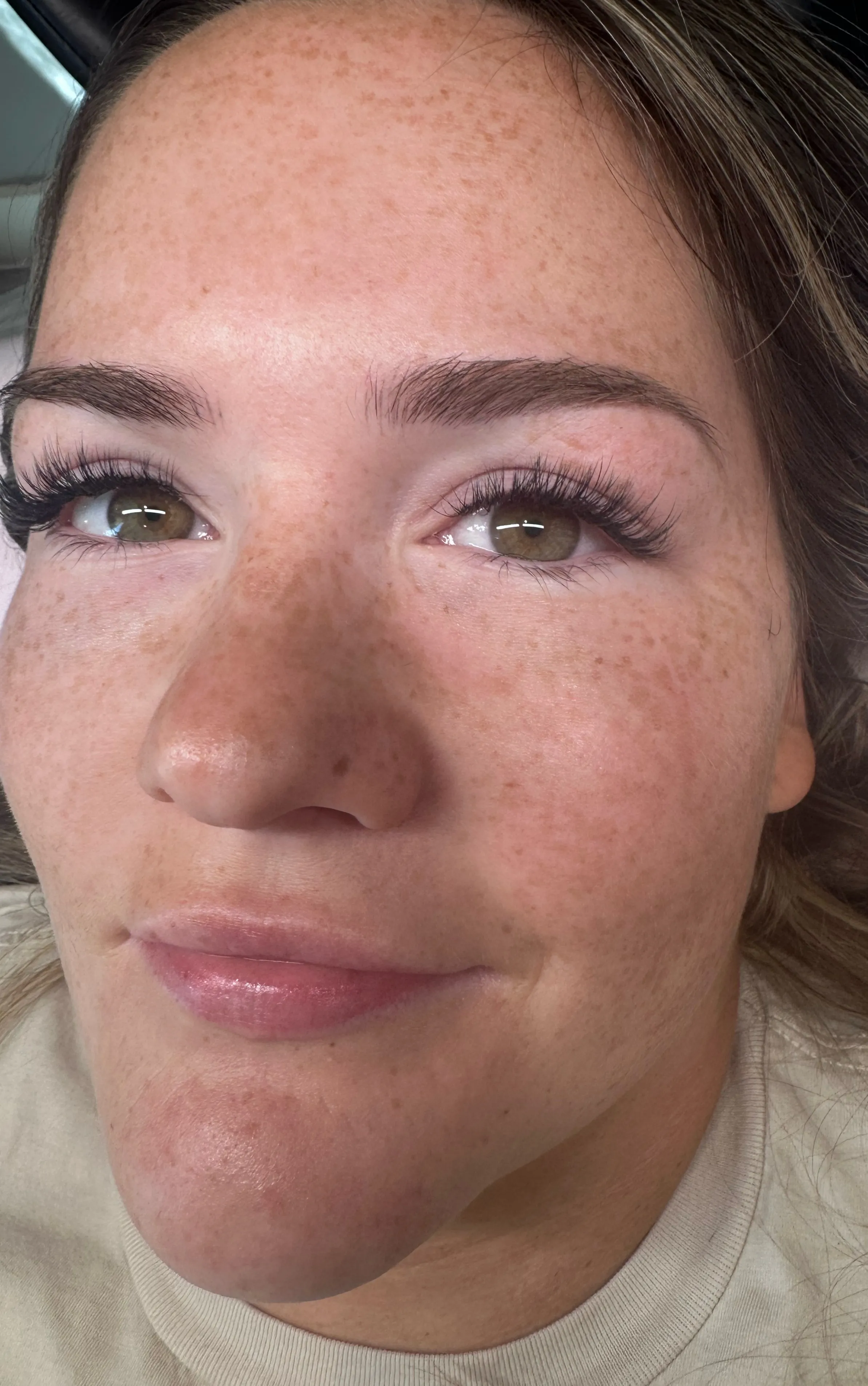 Close-up portrait with long, wispy hybrid lash extensions.